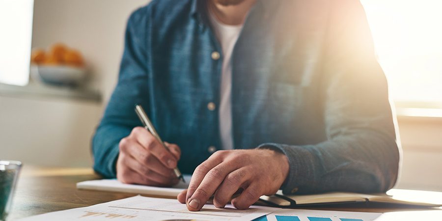 businessman-analysing-statistical-charts-P8L88DY